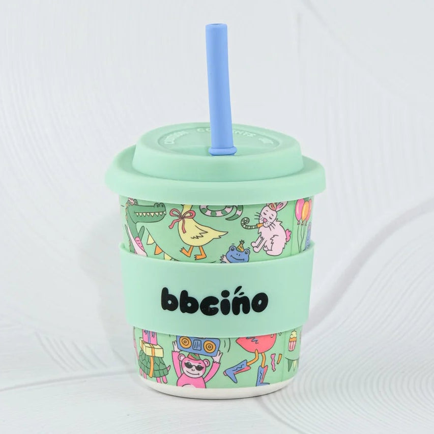 Mint green tumbler with colorful design and straw on a white background