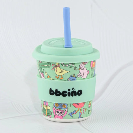 Mint green tumbler with colorful design and straw on a white background