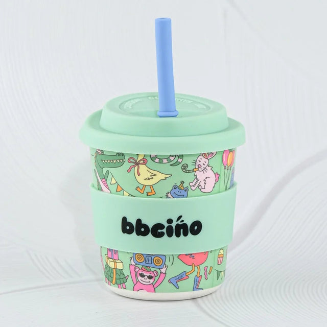 Mint green tumbler with colorful design and straw on a white background